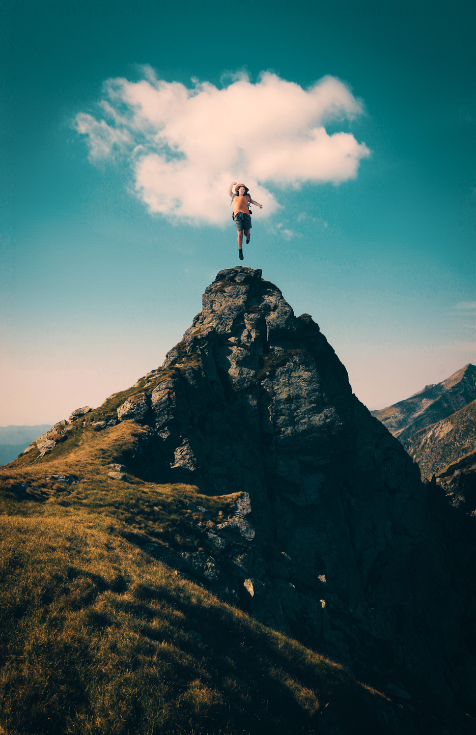 Hiker celebrating success on top of a mountain.